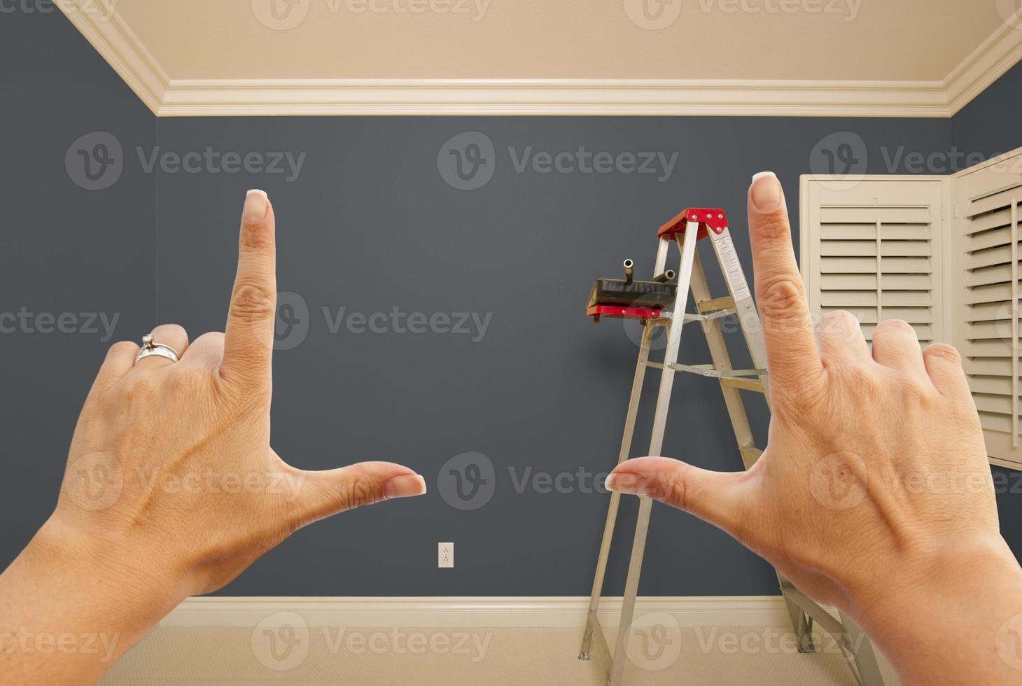 Hands Framing Grey Painted Wall Interior photo
