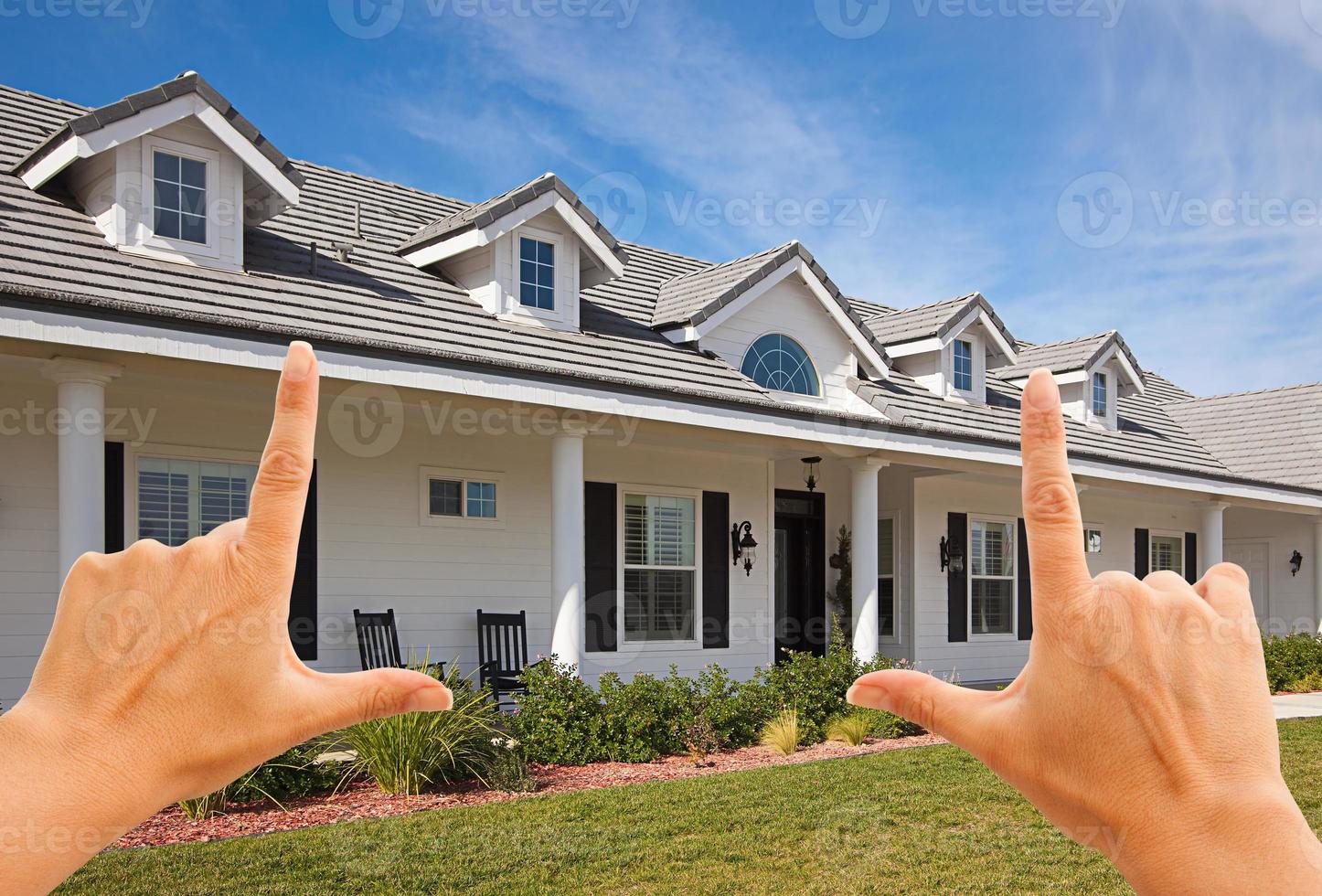 Female Hands Framing Beautiful House photo