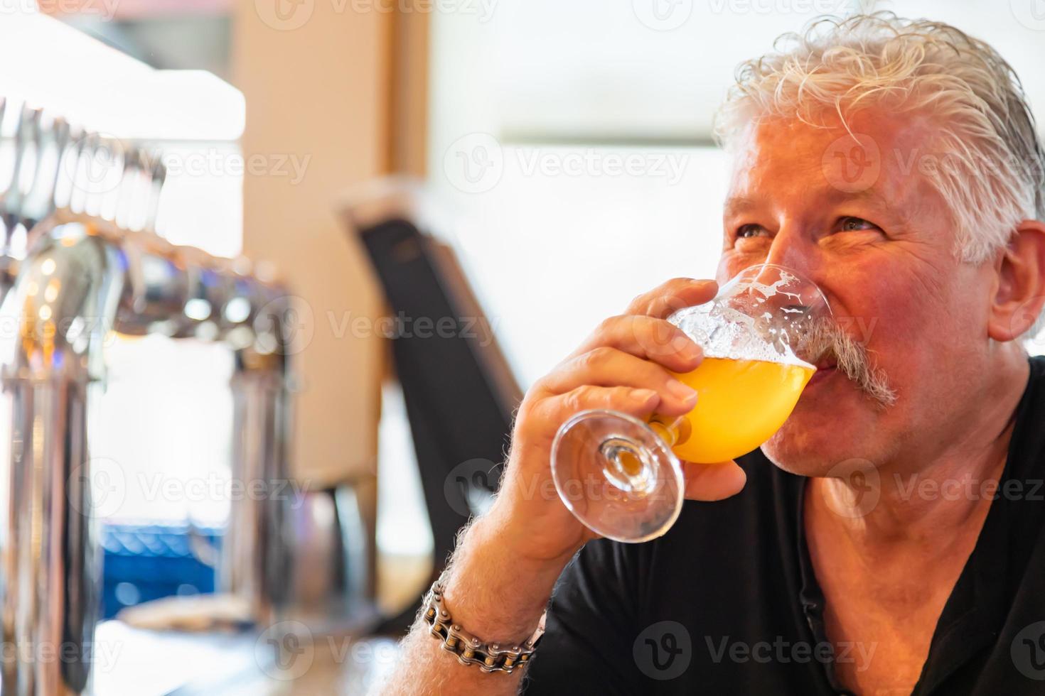 Handsome Man Tasting A Glass Of Micro Brew Beer photo