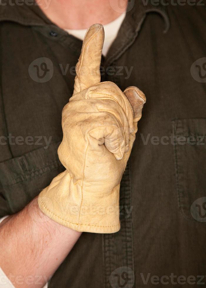 hombre con guante de construcción de cuero y gesto número uno foto