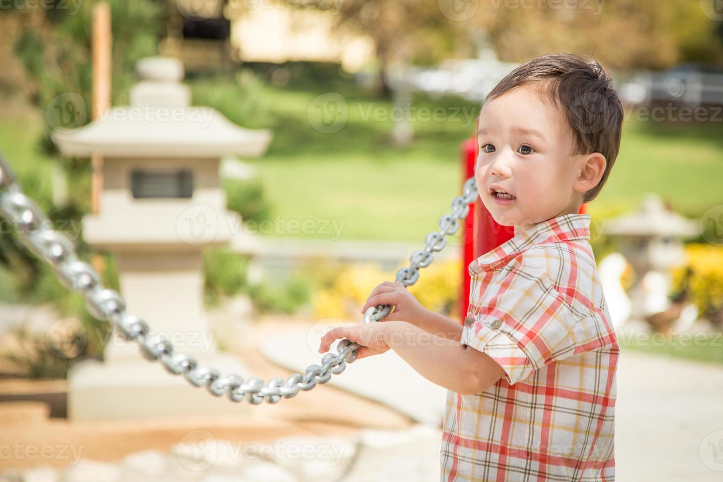 Young Chinese and Caucasian Boy Having Fun at the Park. photo