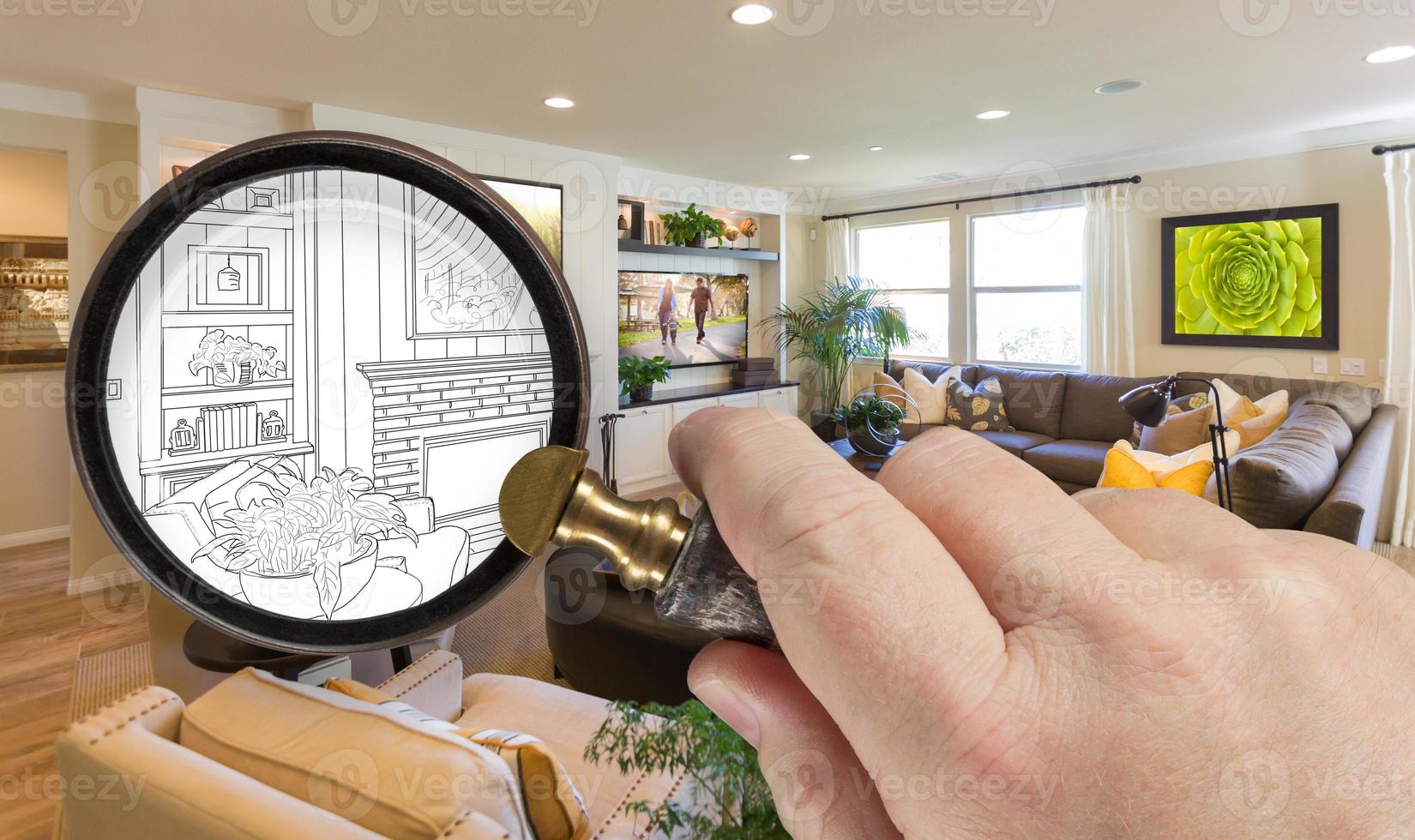Hand Holding Magnifying Glass Revealing Custom Living Room Design Drawing and Photo Combination