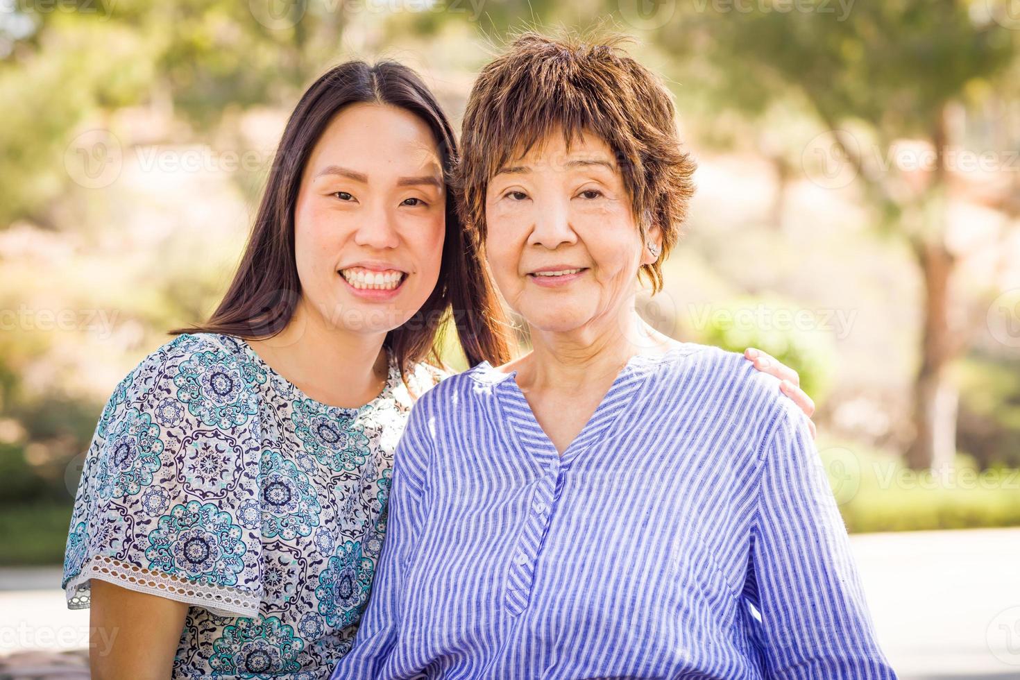 Outdoor portrait of a happy Chinese mother and daughter photo