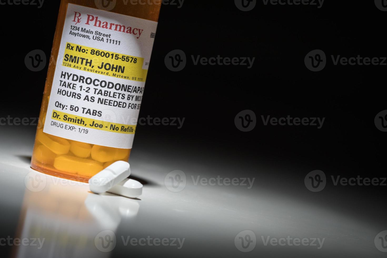 Hydrocodone Pills and Prescription Bottle with Non Proprietary Label. No model release required - contains fictitious information. photo