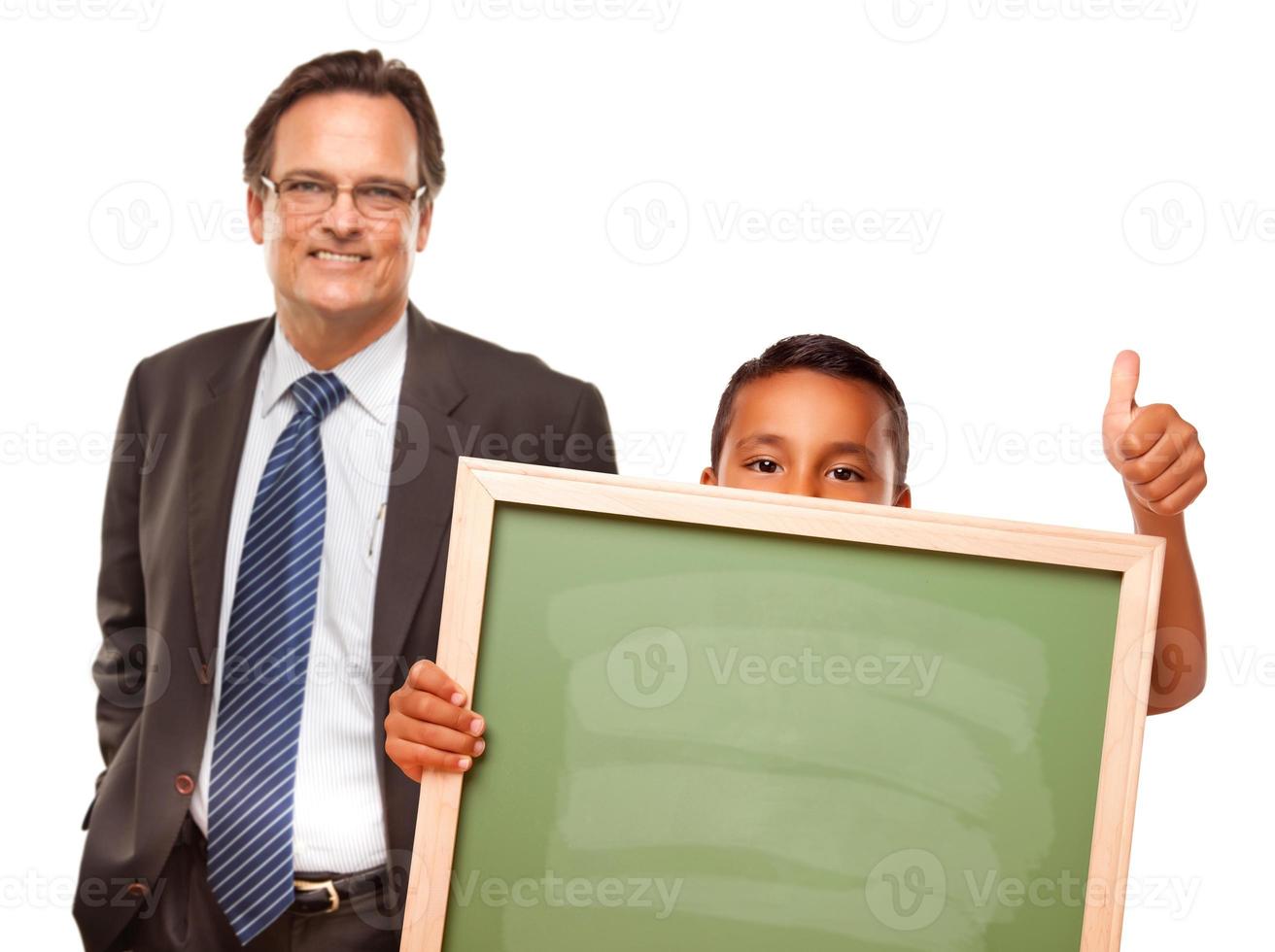 Hispanic Boy Holding Chalk Board with Male Teacher Behind photo