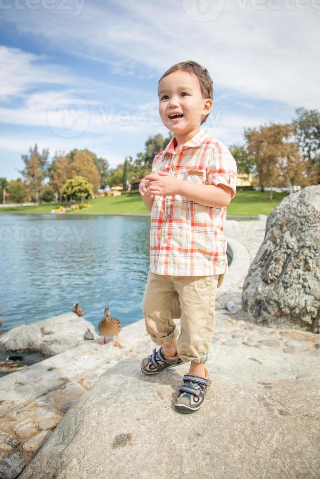 Young Chinese and Caucasian Boy Having Fun at the Park and Duck Pond. photo