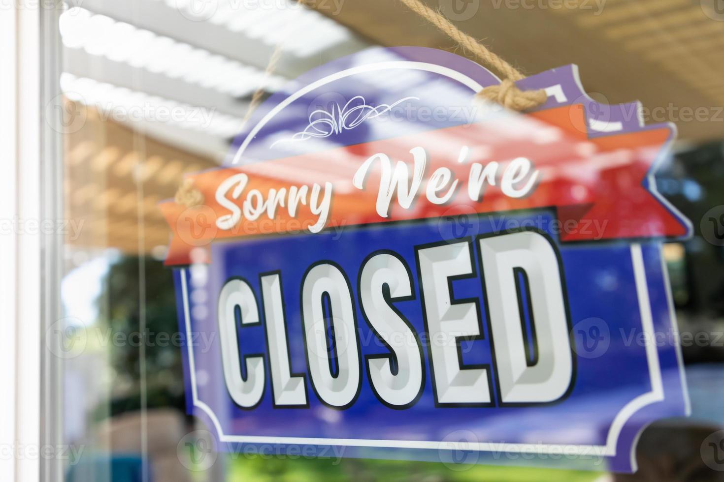 Storefront Closed Sign Through Window photo