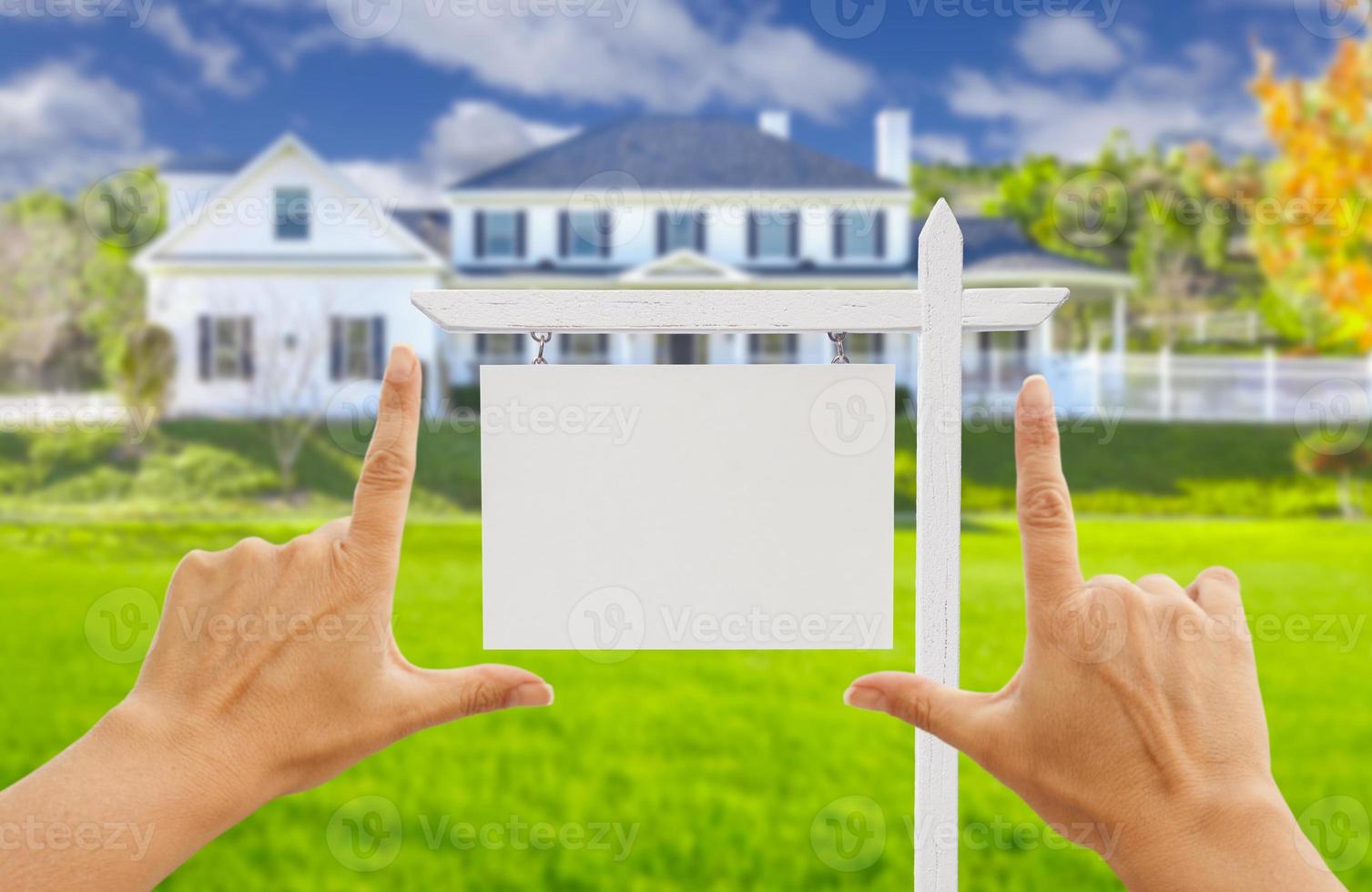 Hands Framing Blank Real Estate Sign and New House photo