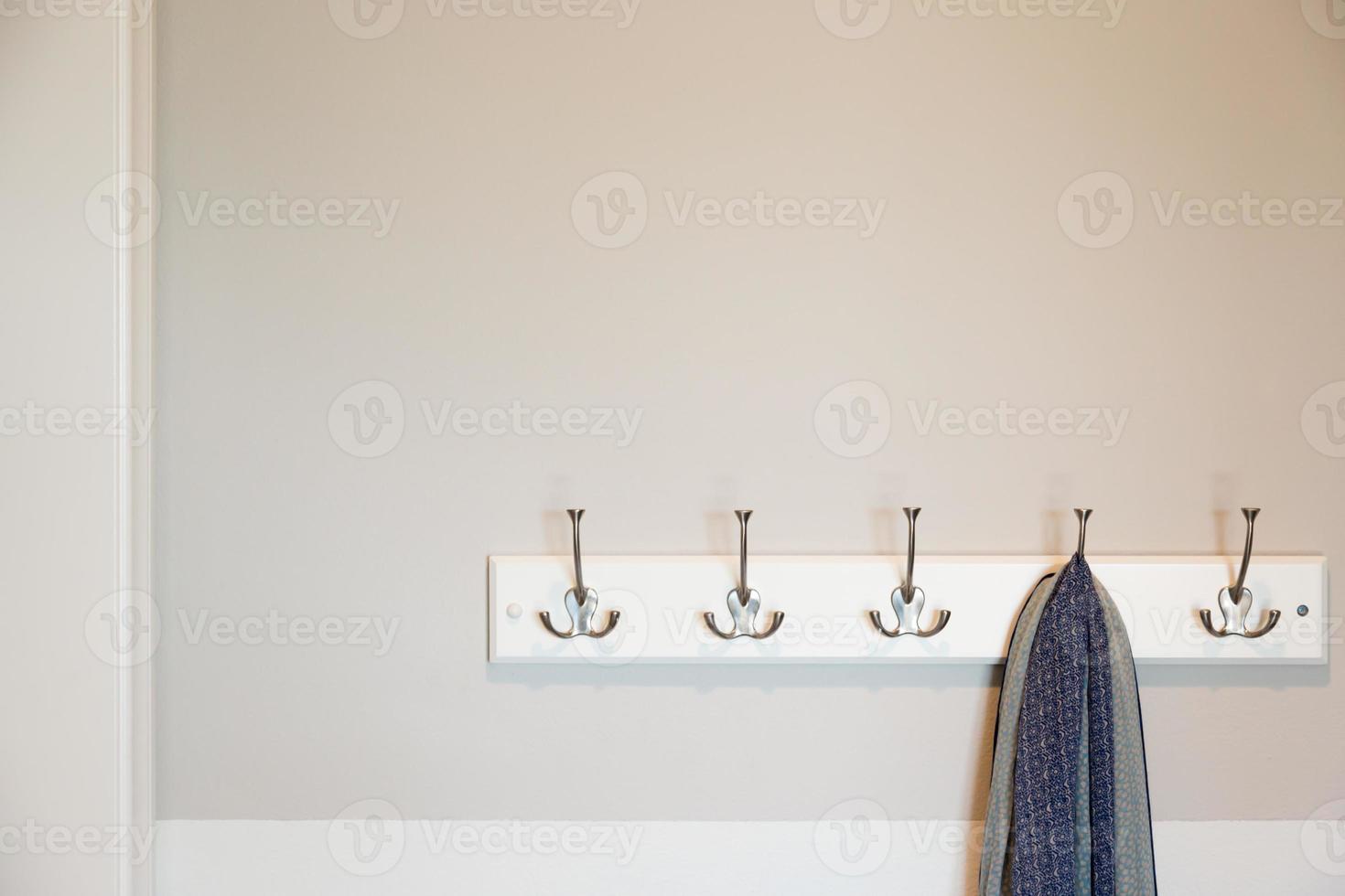 Wall in House with Scarf Hanging on Coat Rack Hooks Abstract photo