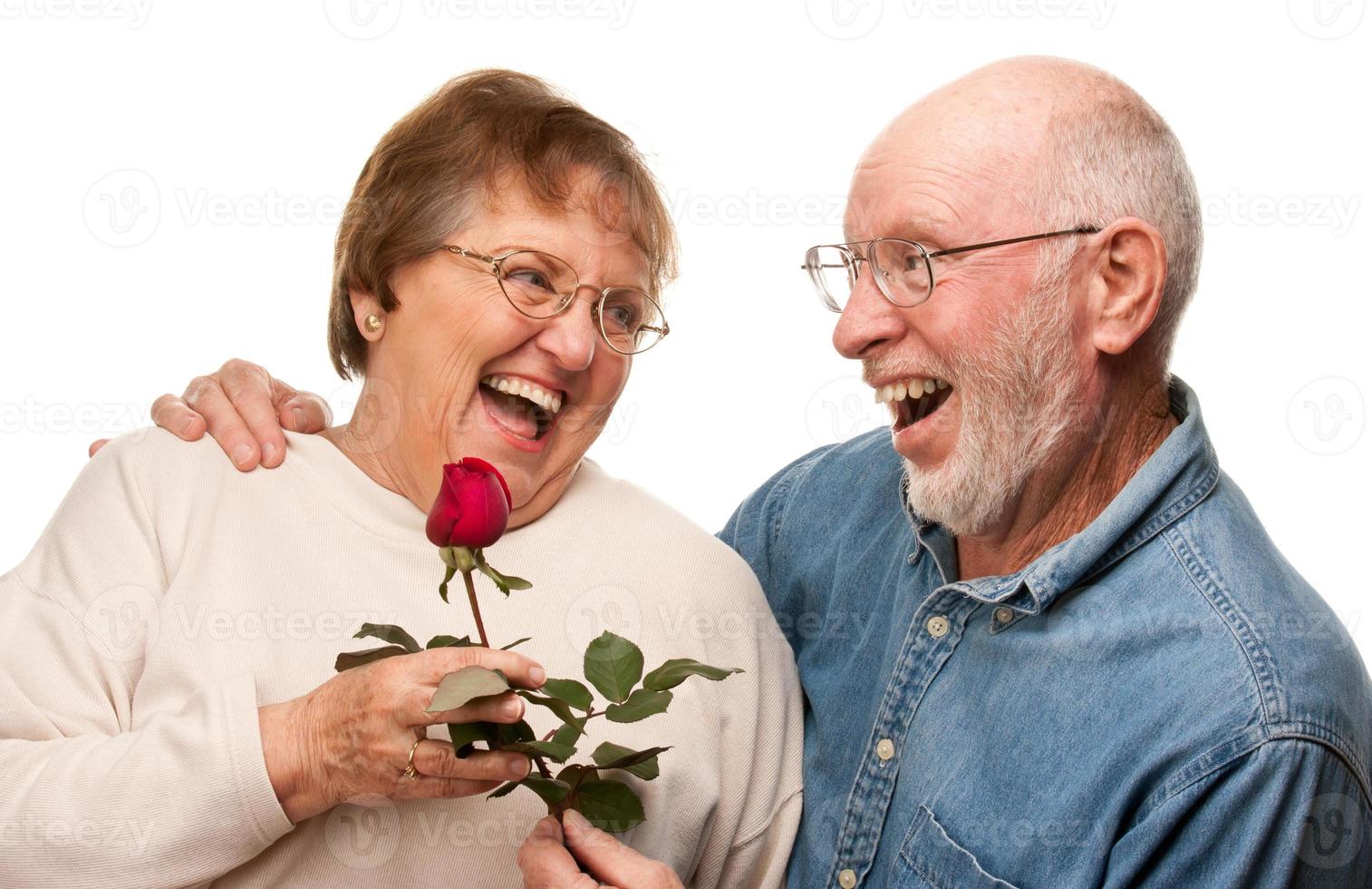 Happy Senior Husband Giving Red Rose to Wife photo