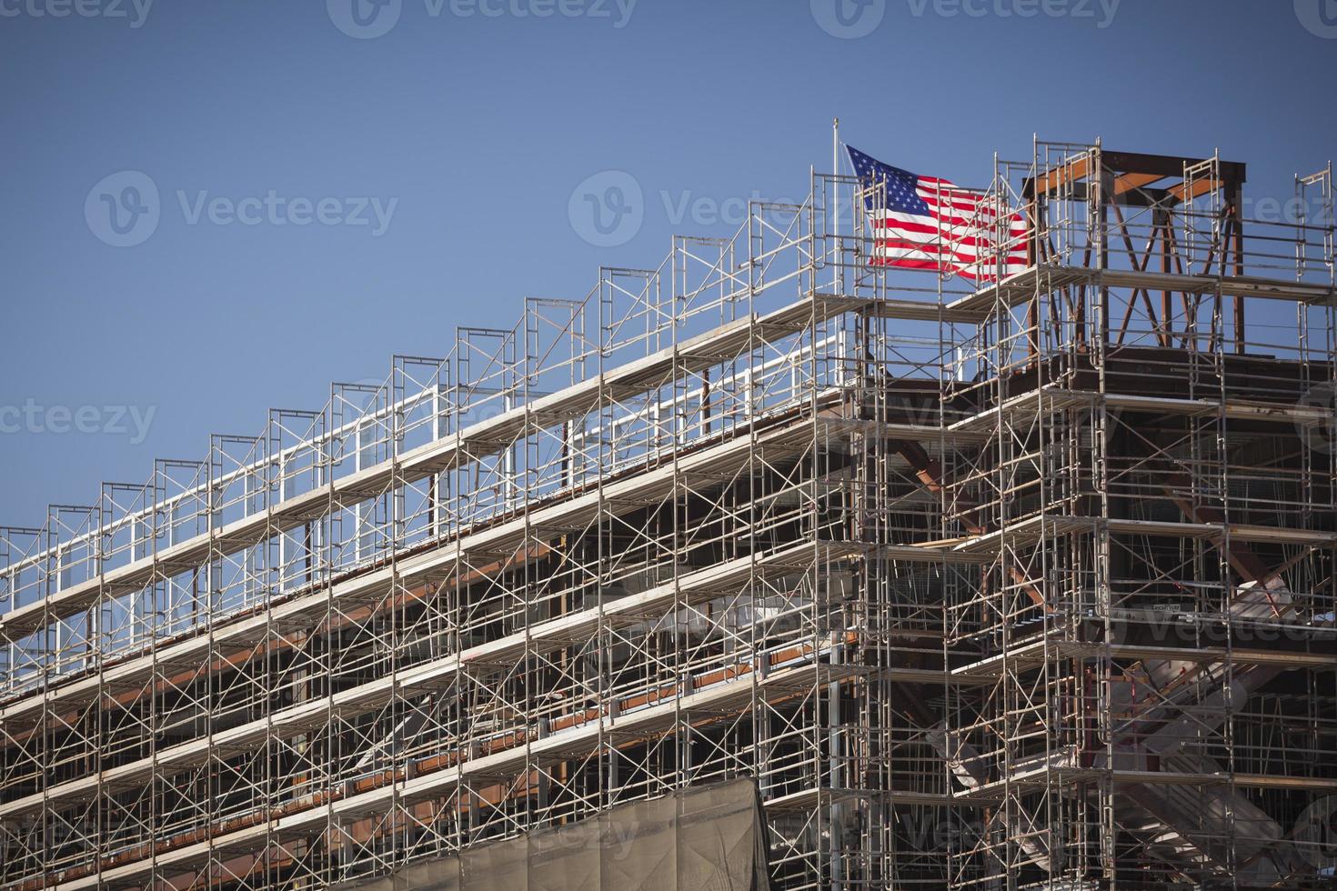 American Flag Flying on Top of New Building Construction photo
