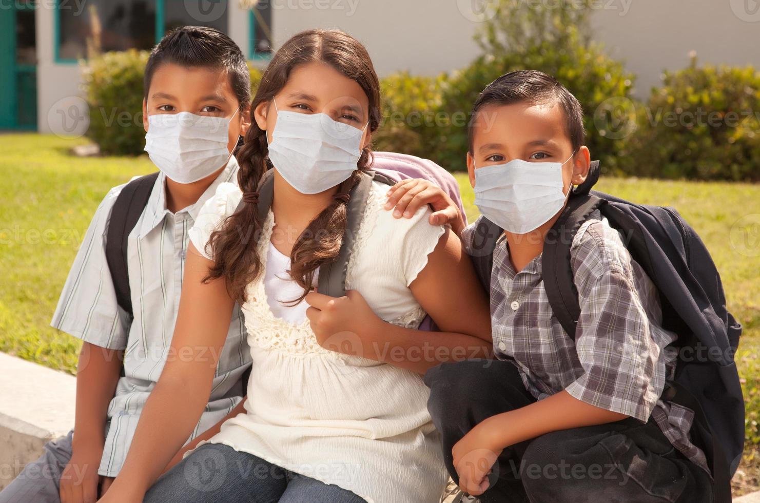 Young Hispanic Students on School Campus Wearing Medical Face Masks photo