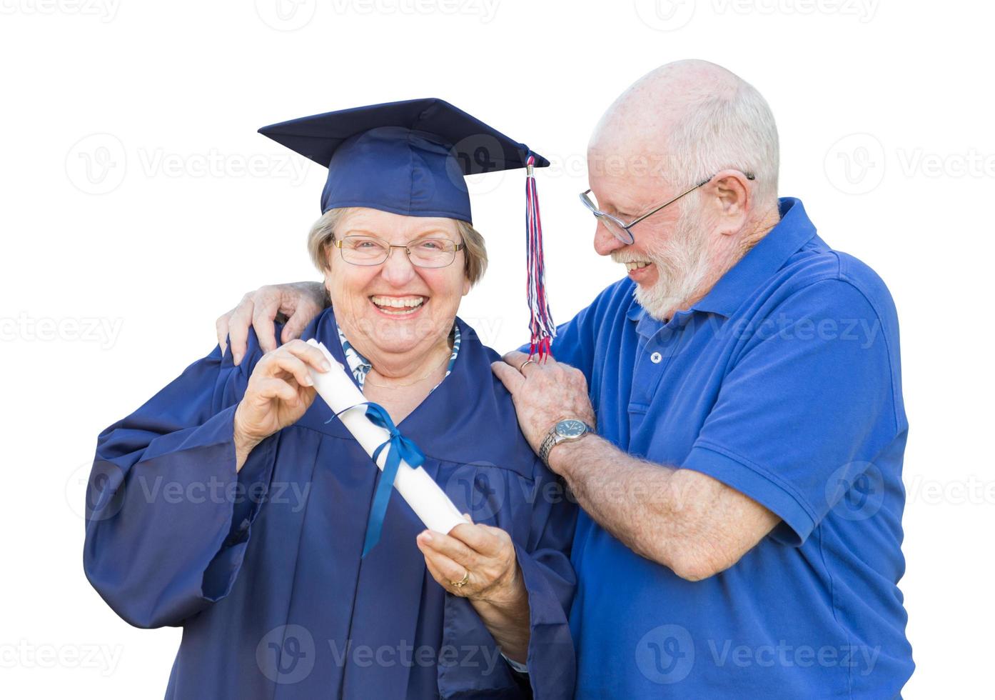 Senior Adult Woman Graduate in Cap and Gown Being Congratulated By Husband Isolated on White. photo