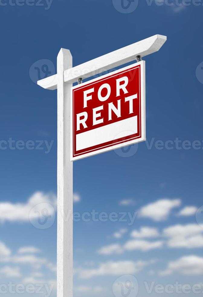 Right Facing For Rent Real Estate Sign on a Blue Sky with Clouds. photo