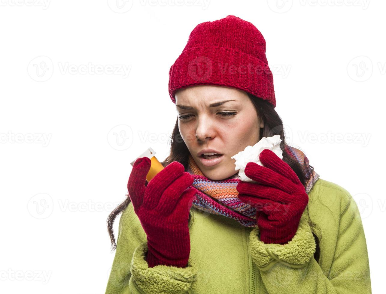 Sick Mixed Race Woman with Empty Medicine Bottles Blowing Nose photo