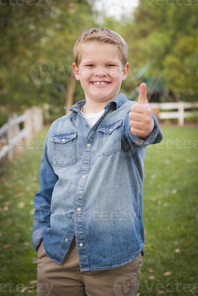 Handsome Young Boy Giving the Thumbs Up photo