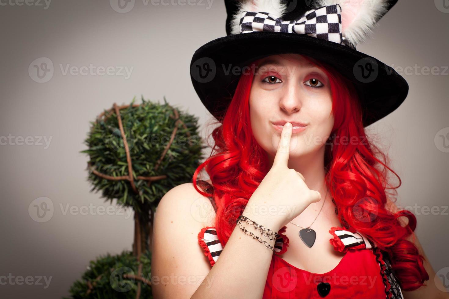 Attractive Red Haired Woman Wearing Bunny Ear Hat photo