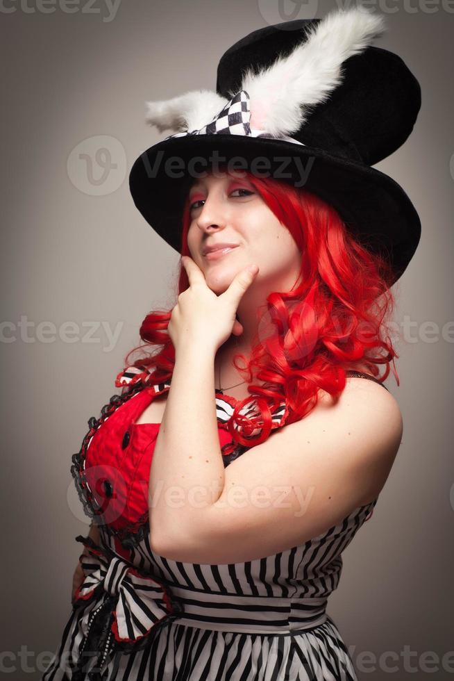 Attractive Red Haired Woman Wearing Bunny Ear Hat photo