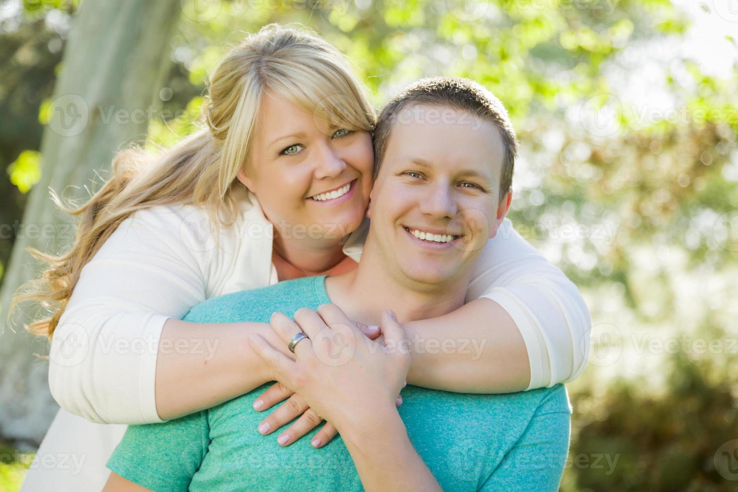 Young Attractive Couple Hugging in the Park photo