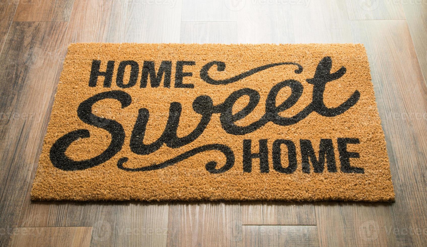 alfombra de bienvenida hogar dulce hogar en el piso foto