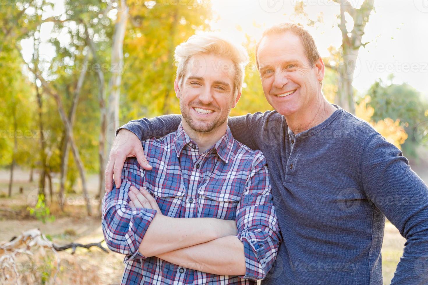 Retrato caucásico feliz del padre y del hijo al aire libre foto