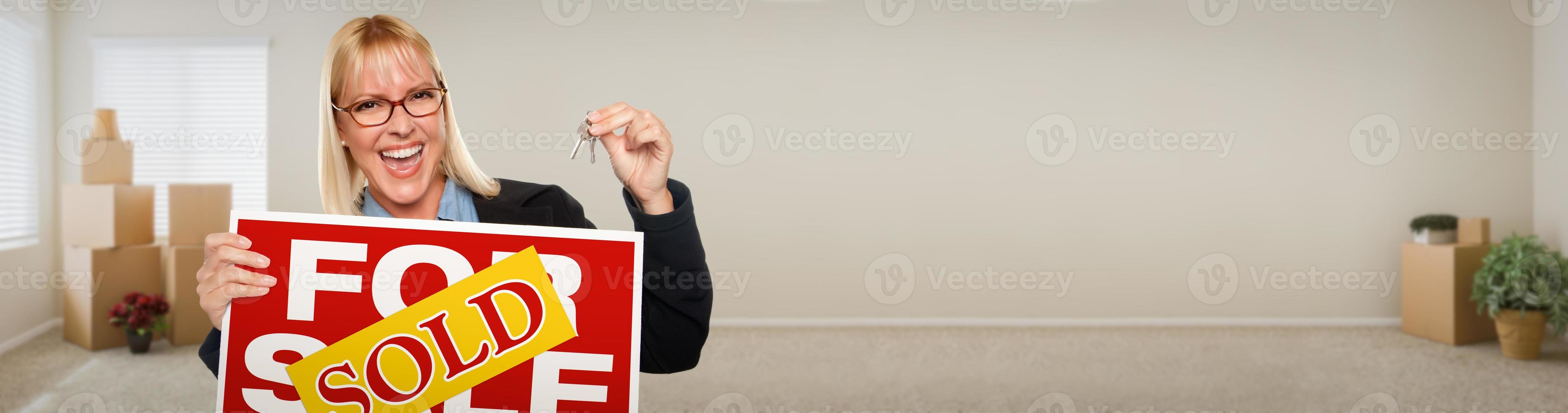 Banner of Adult Woman Inside Room with Boxes Holding House Keys and Sold For Sale Real Estate Sign. photo