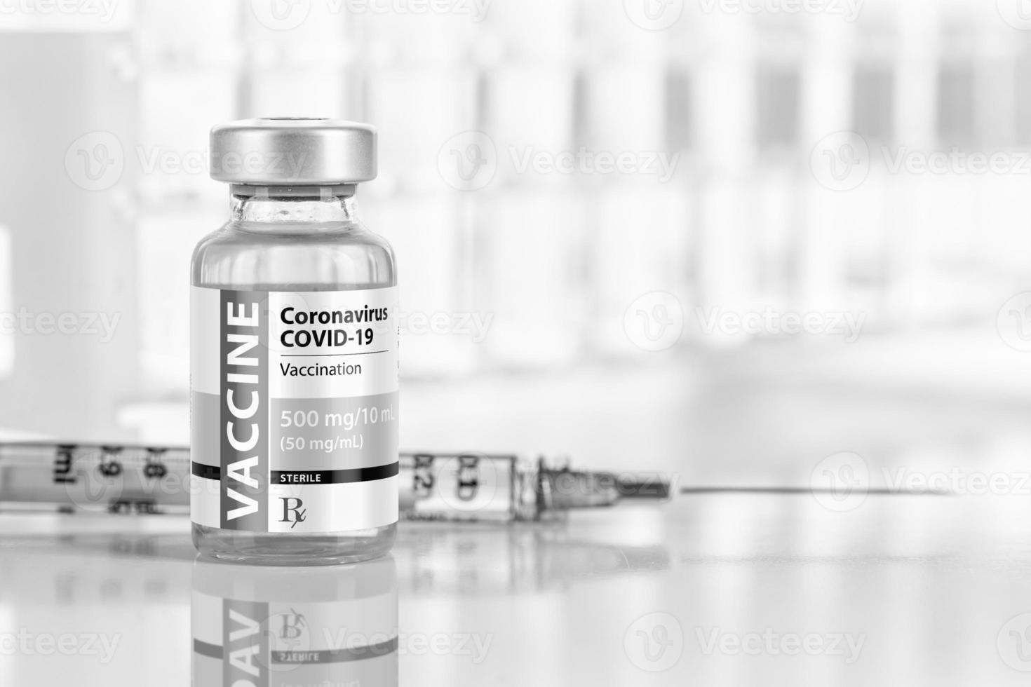 Coronavirus COVID-19 Vaccine Vial and Syringe On Reflective Surface Near Test Tubes photo