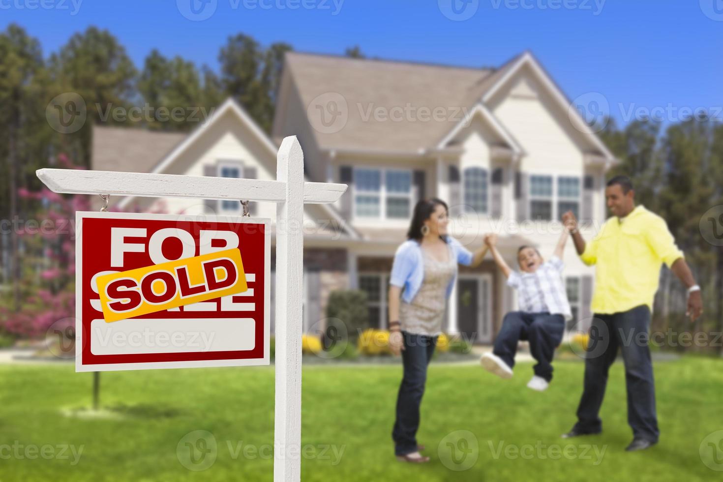 Hispanic Family in Front of Sold Real Estate Sign, House photo