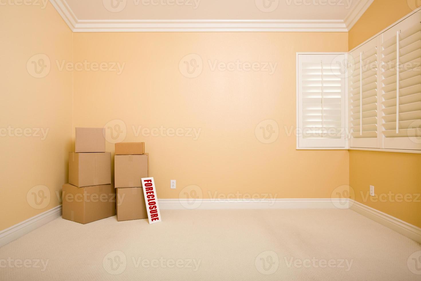 Moving Boxes and Foreclosure Real Estate Sign on Floor in Empty Room photo