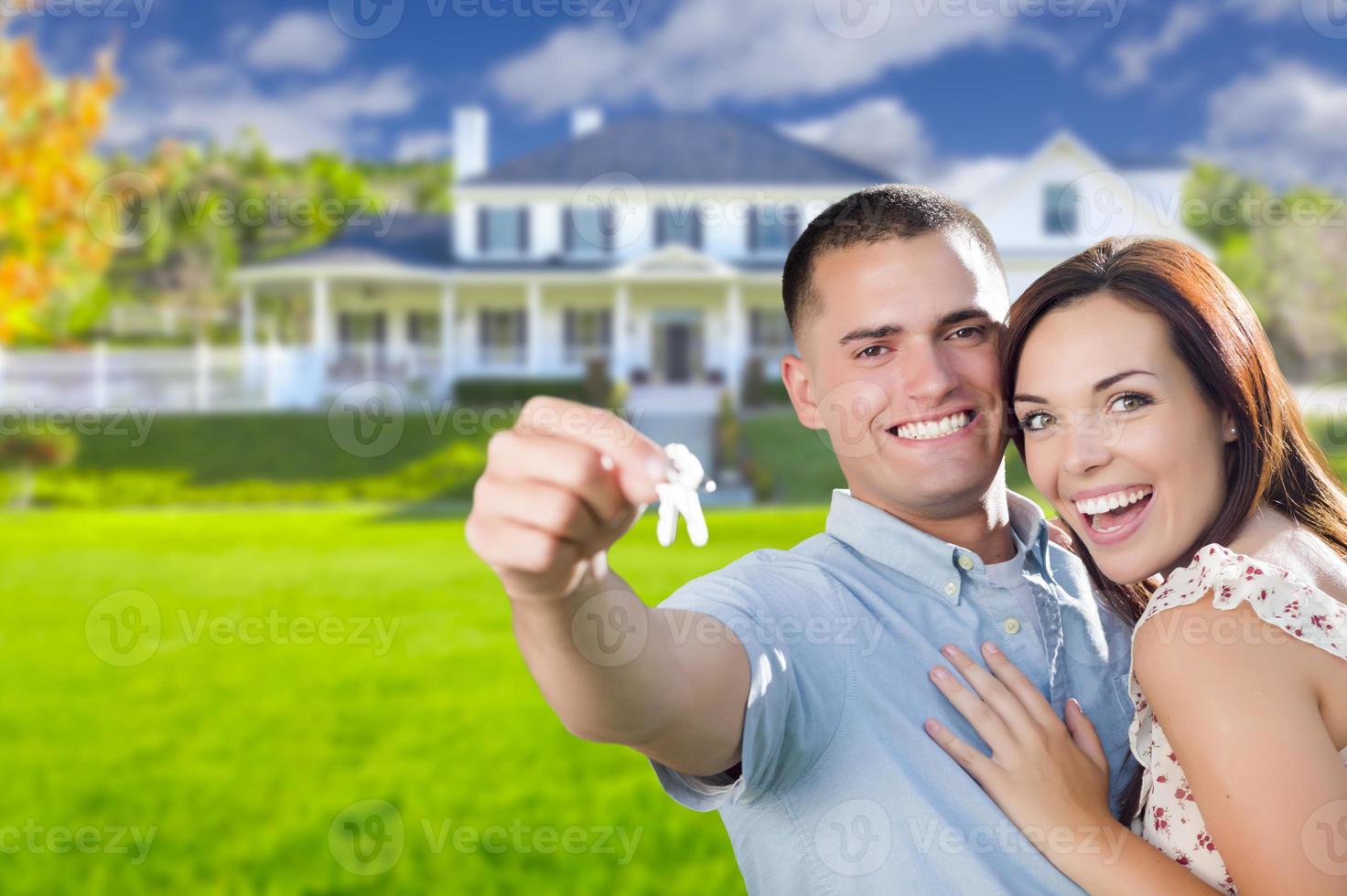 Military Couple with House Keys In Front of New Home photo