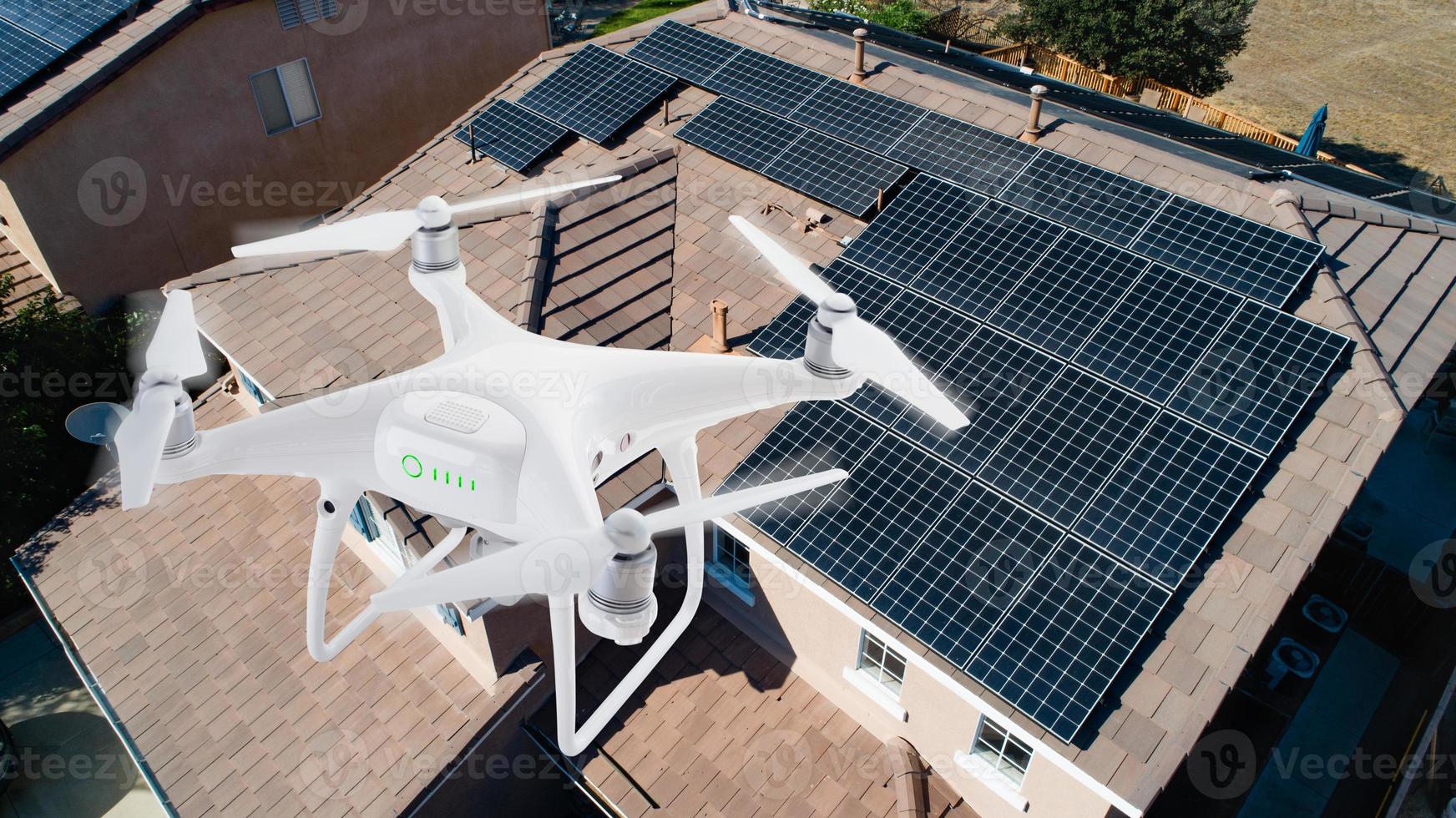 UAV Drone Inspecting Solar Panels On Large House photo