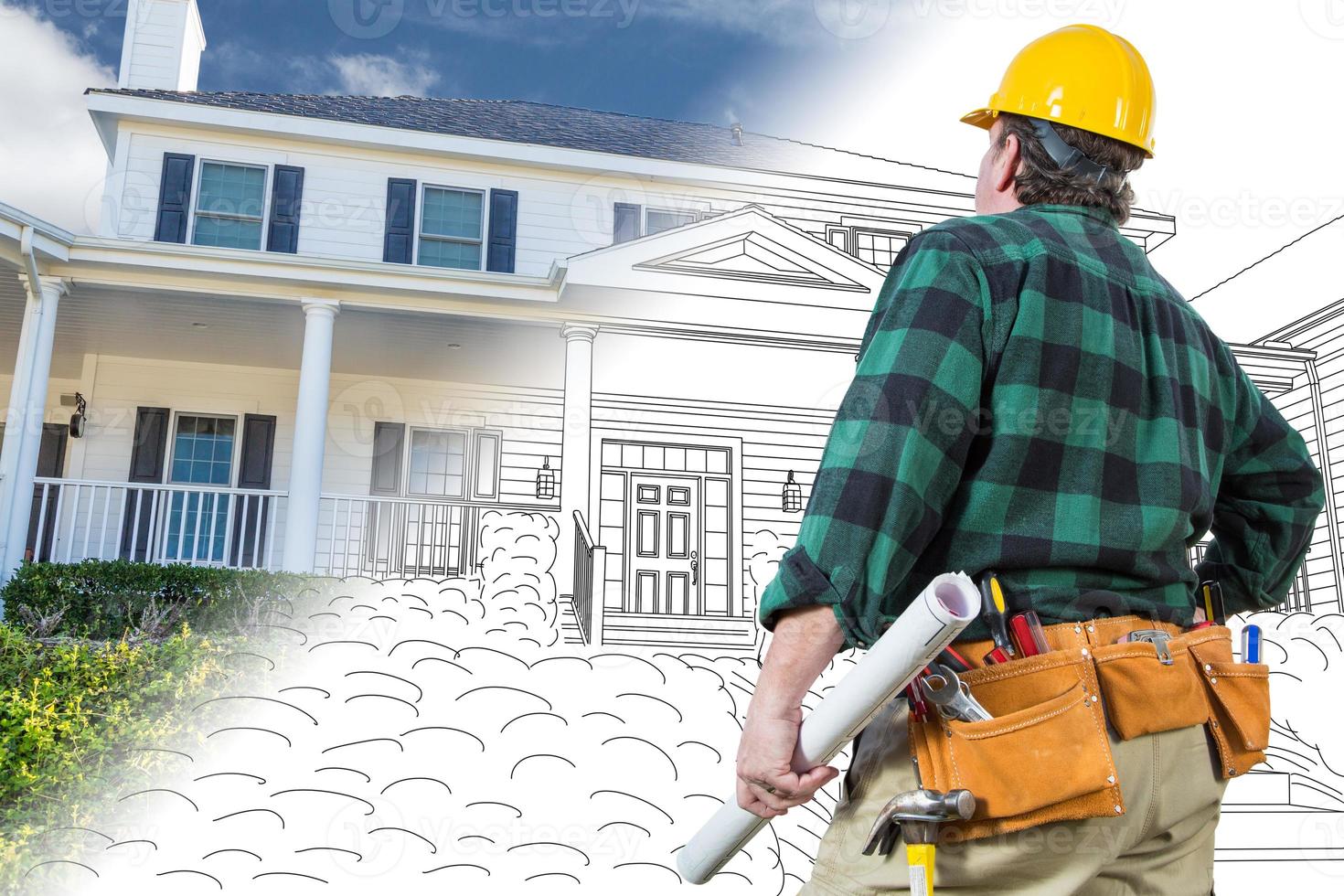 Male Contractor with Hard Hat and Tool Belt Looking At Custom House Drawing Photo Combination On White.