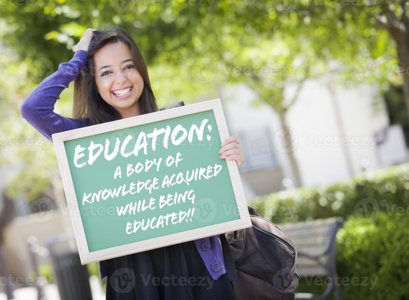 Mixed Race Female Student Holding Chalkboard With Education and Definition photo