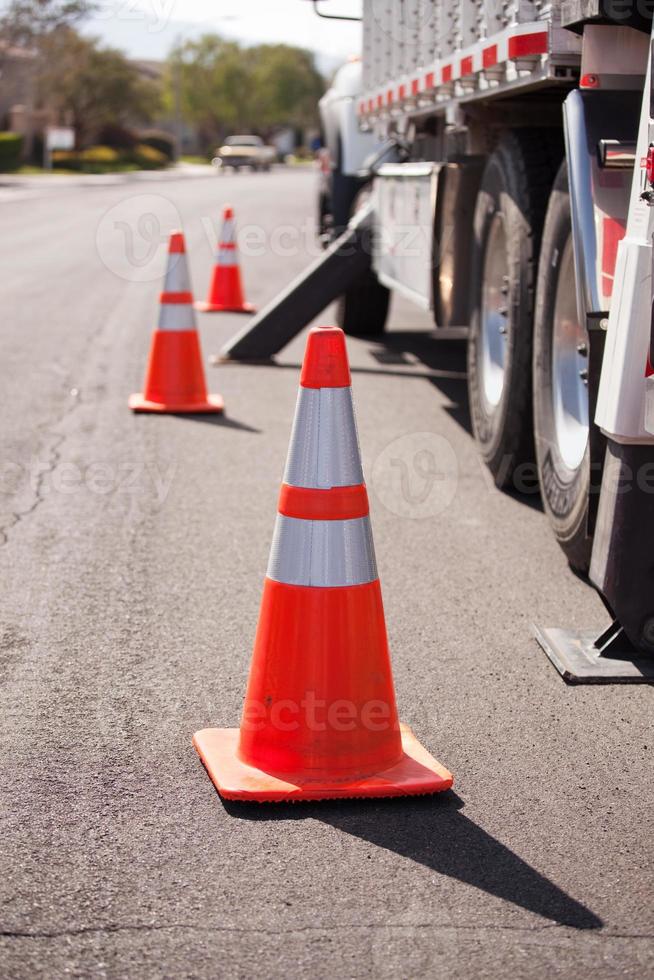 Orange Hazard Cones and Utility Truck in Street photo