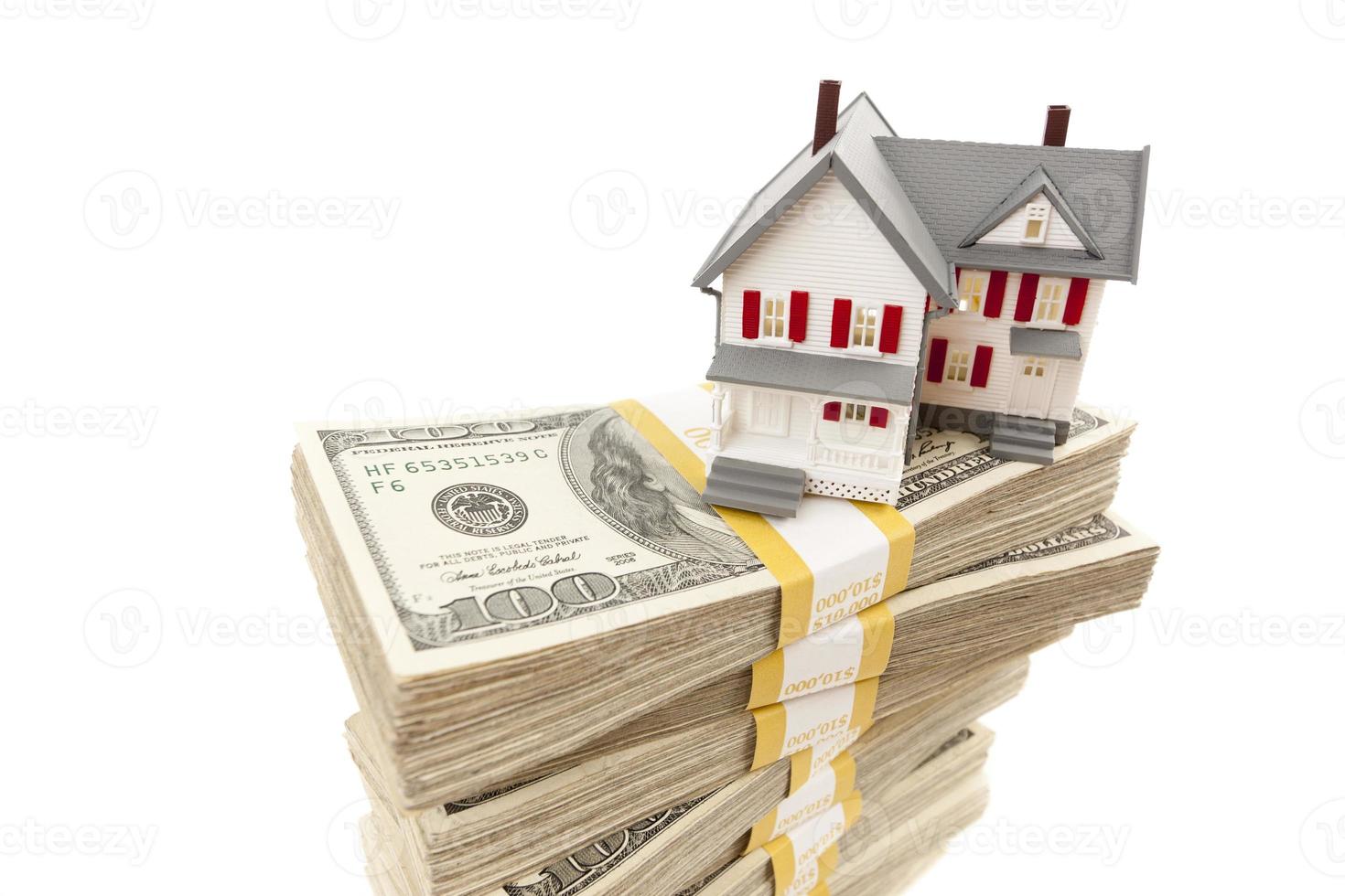 Small House on Stacks of Hundred Dollar Bills photo