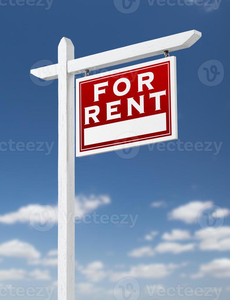 Right Facing For Rent Real Estate Sign on a Blue Sky with Clouds. photo