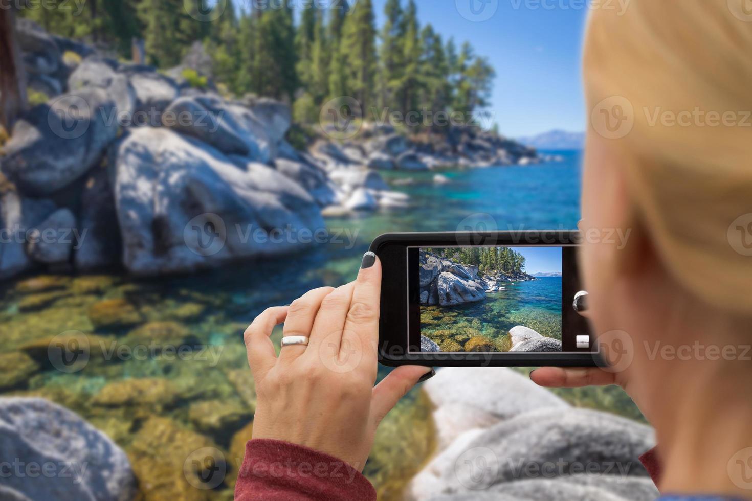 Woman Taking A Beautiful Lake Picture with Her Smart Phone photo