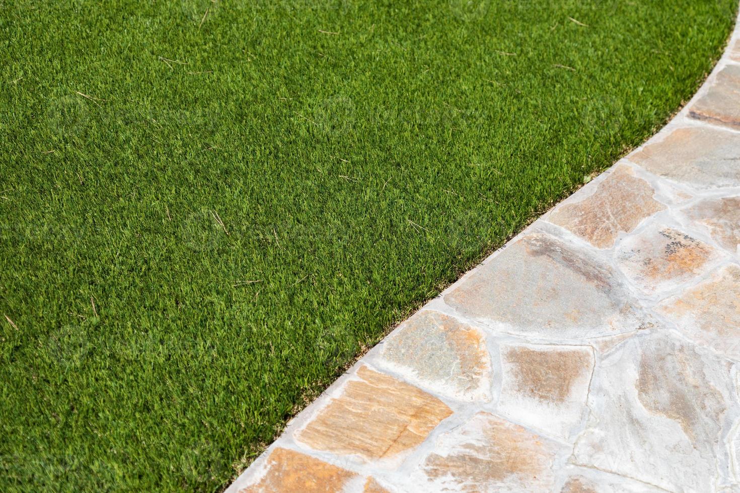 New Artificial Grass Installed Near Walkway. photo