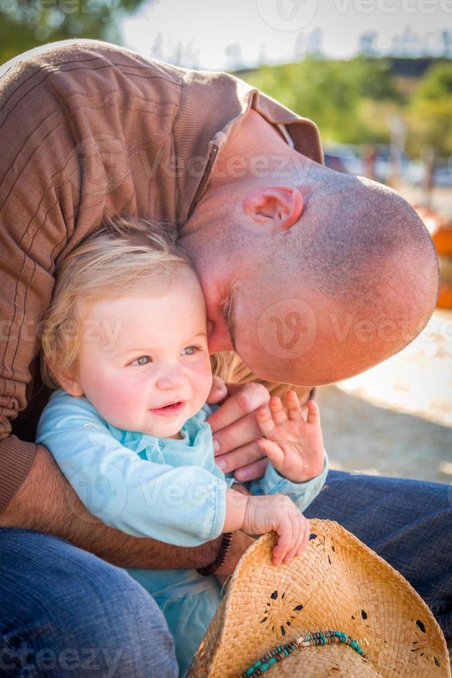 Adorable Young Family Enjoys a Day at the Pumpkin Patch. photo