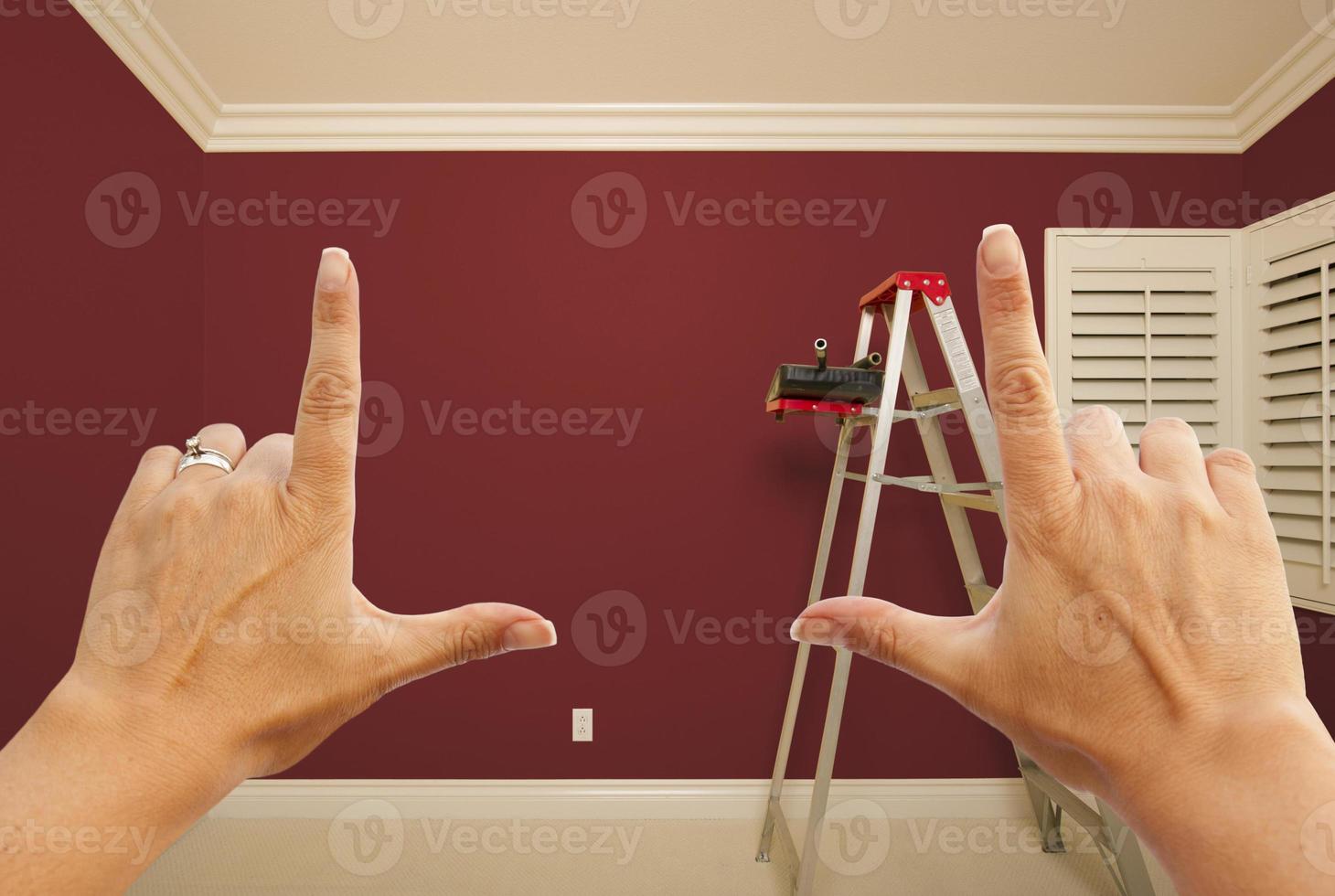 Hands Framing Deep Red Painted Wall Interior photo