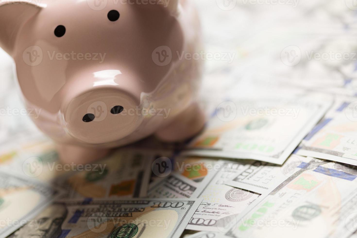 Piggy Bank On Pile on United States One Hundred Dollar Bills photo