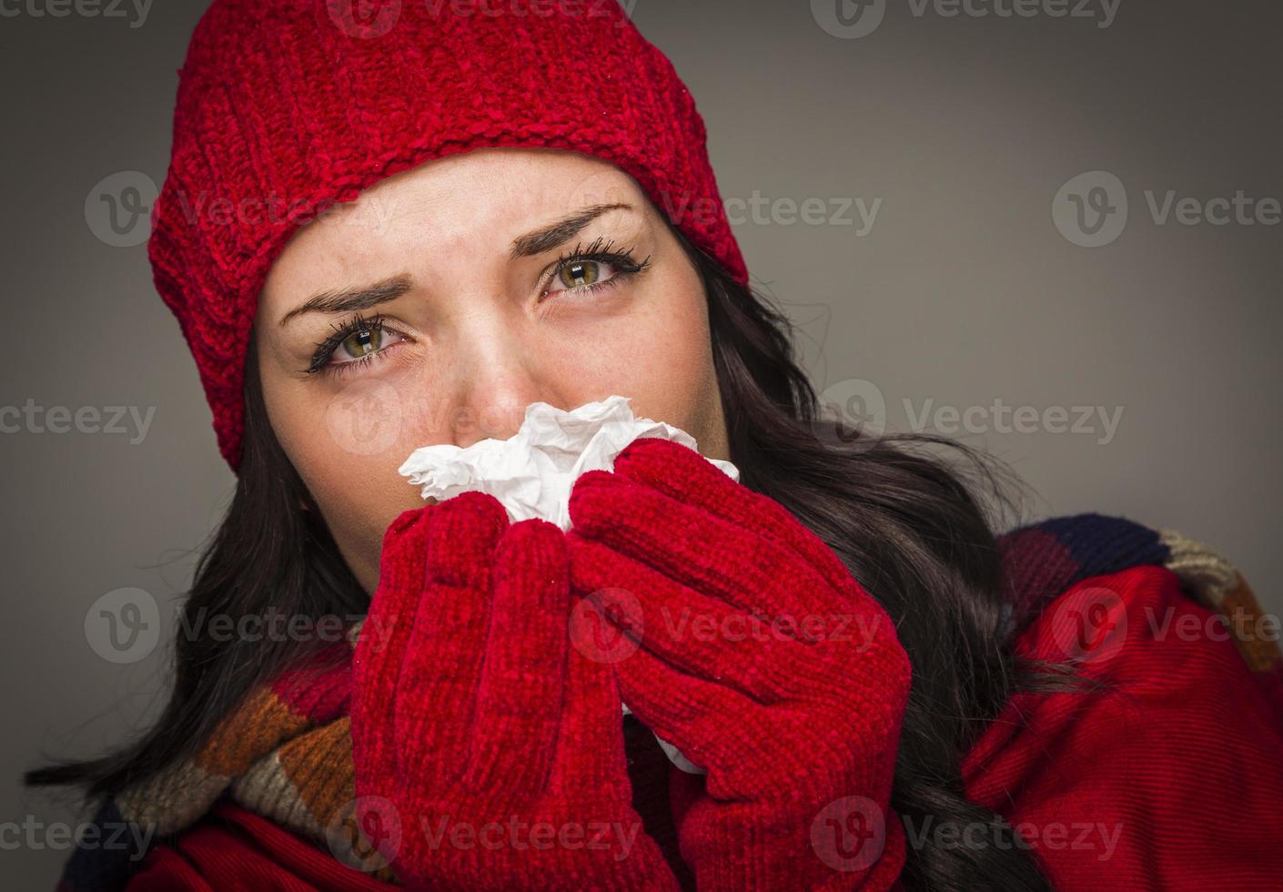 Sick Mixed Race Woman Blowing Her Sore Nose With Tissue photo