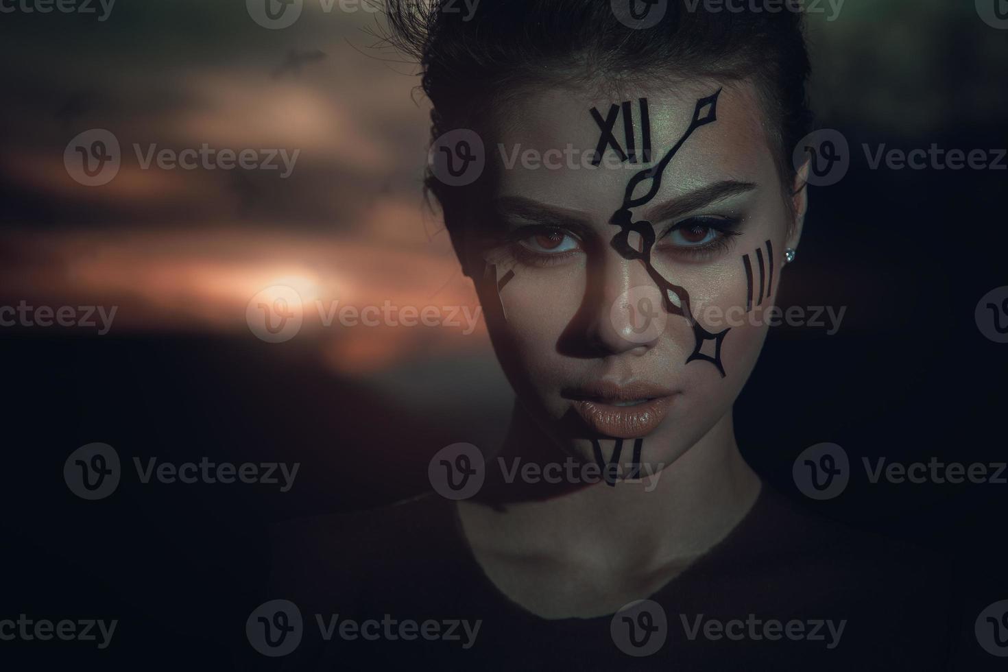 time keeper. watchman. woman with watch on face at sunset photo