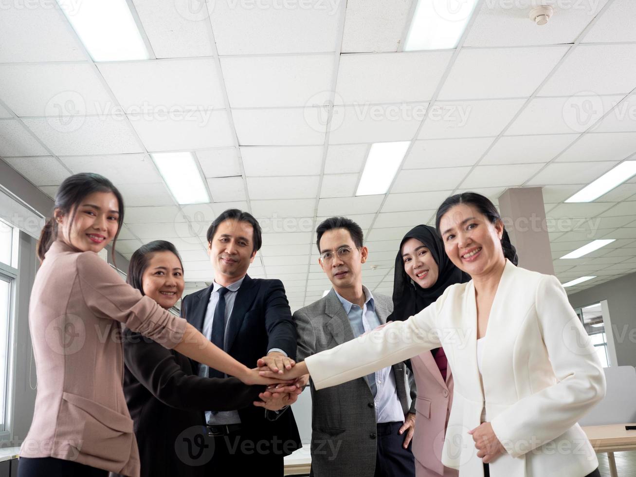 Businesswoman businessman male female person smart handsome beautiful pretty group of people look at camera touch hand finger happy smile partner friend teamwork office company corporate together photo