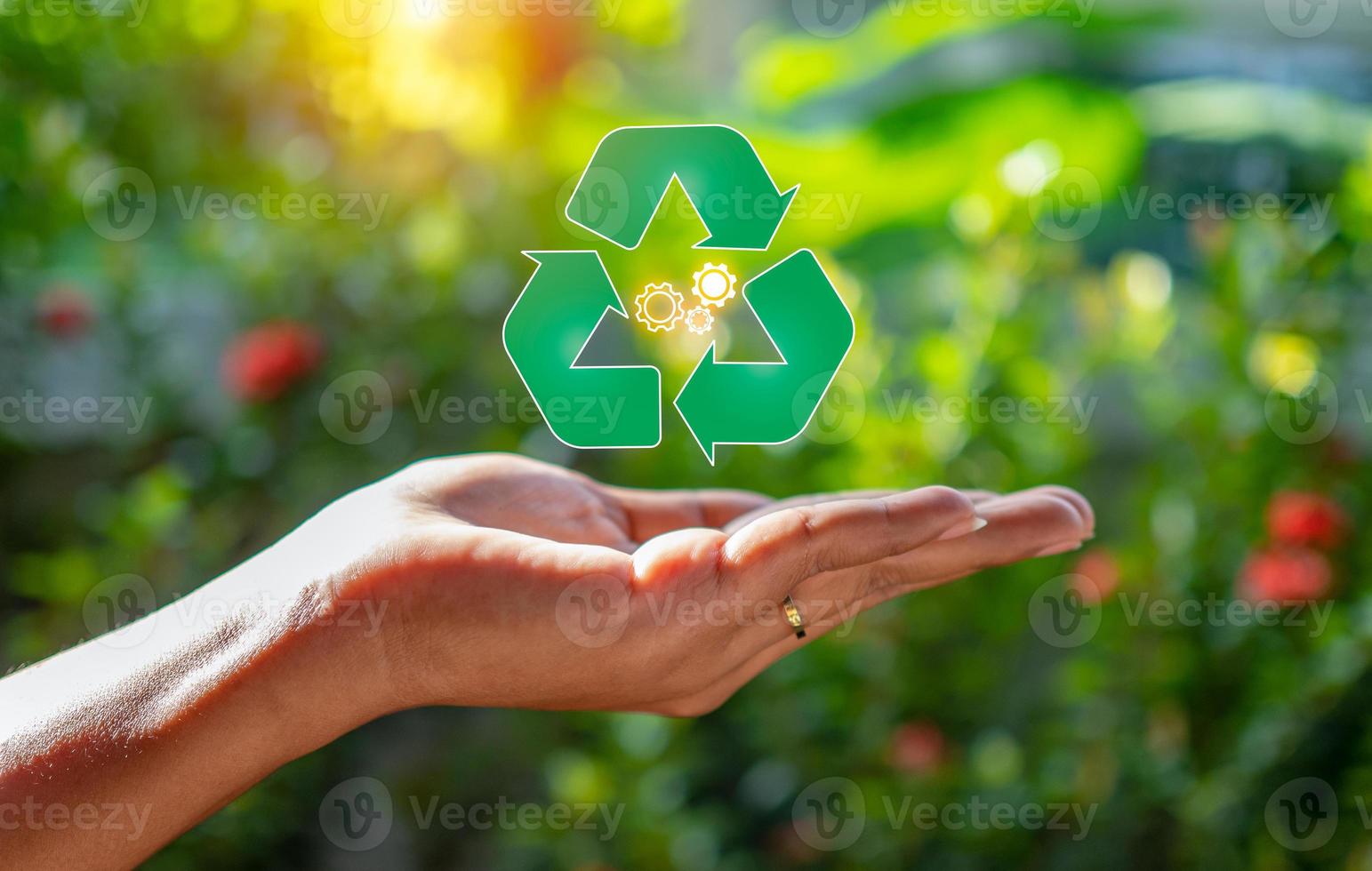 Close up of hand holding green recycle symbol. Recycle concept. photo