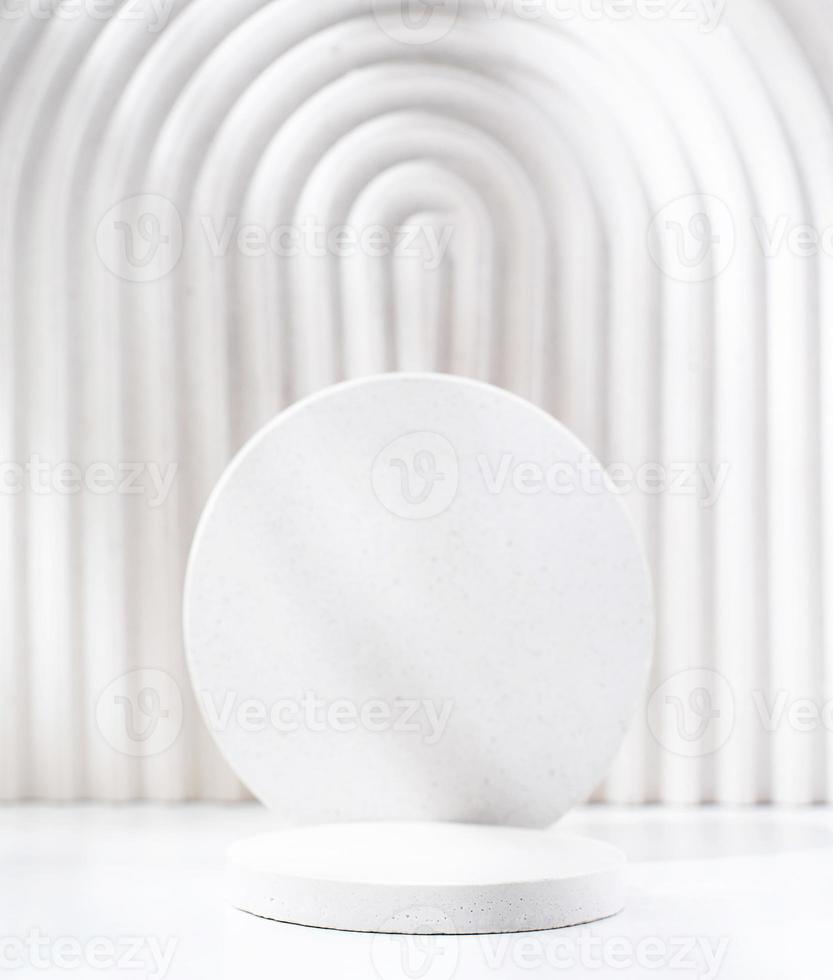 A minimalistic scene of a gypsum podium with stones on white background, for natural cosmetics photo