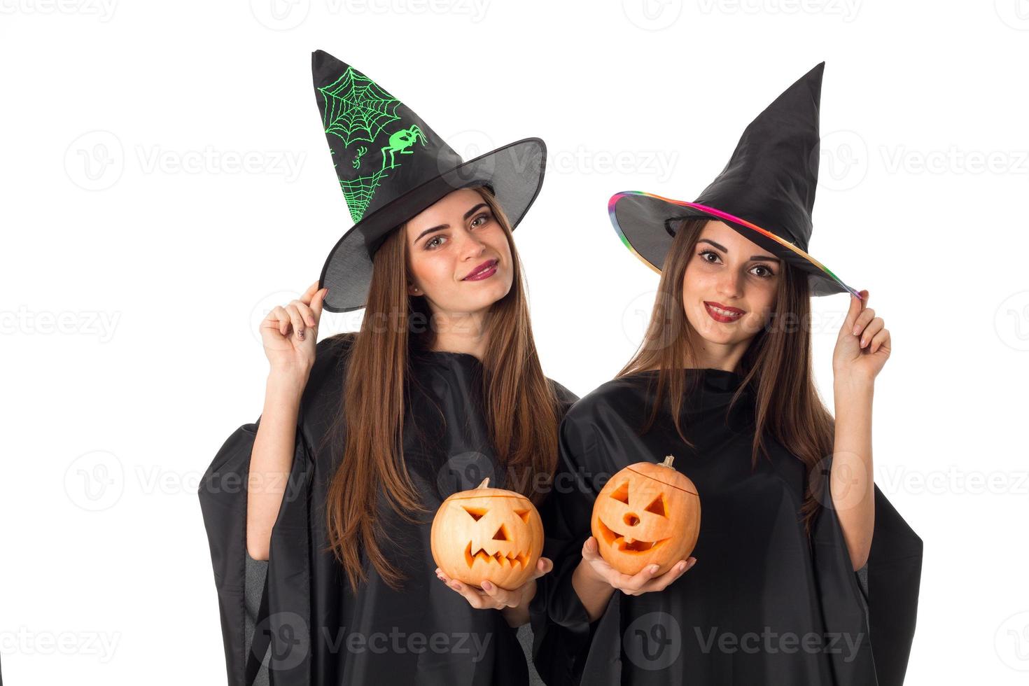 beautiful young girls with pumpkins in hands photo