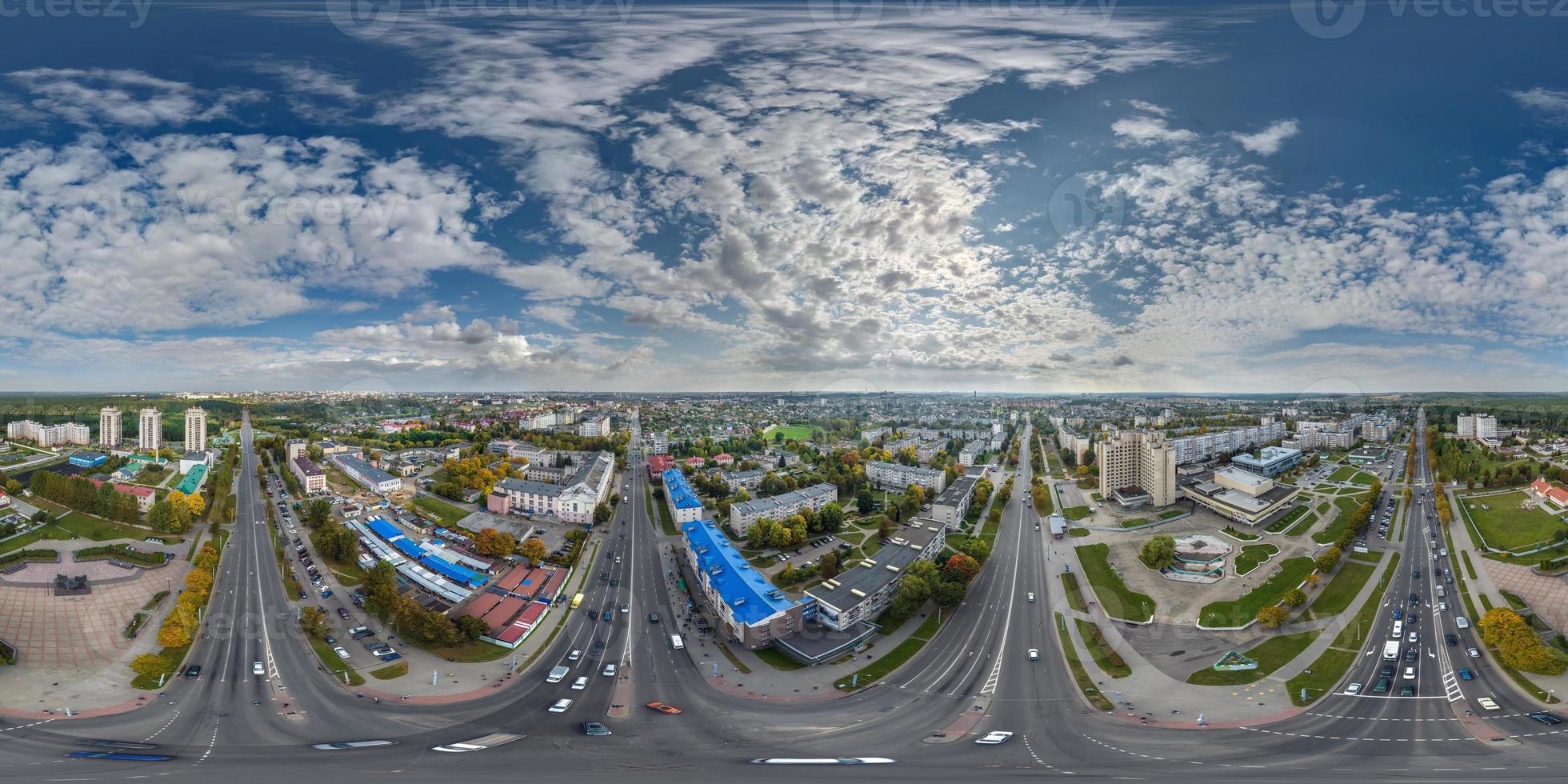 aerial full seamless spherical hdri 360 panorama view above road junction with traffic in city overlooking of residential area of high-rise buildings in equirectangular projection. photo