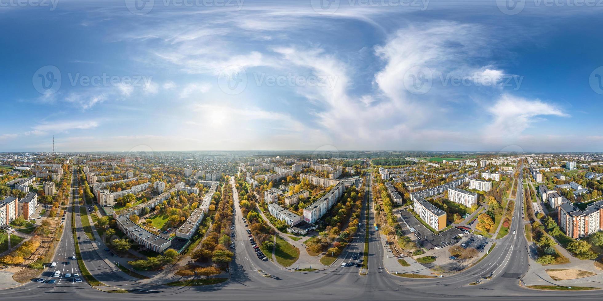 aerial full seamless spherical hdri 360 panorama view above road junction with traffic in city overlooking of residential area of high-rise buildings in equirectangular projection. photo