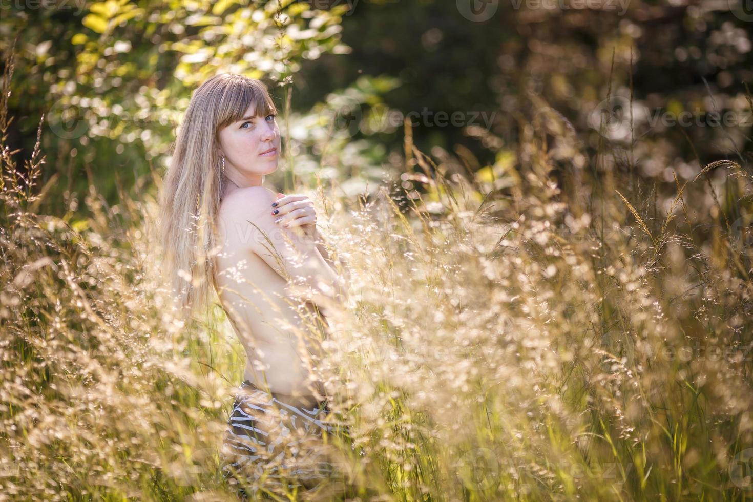 beautiful girl stands in thicket of forest photo